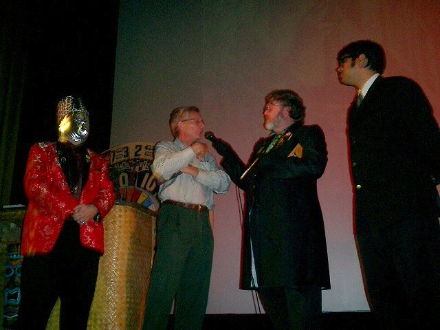 Creature Features legend John Stanley looks terrified by the gang of ghoulish hosts grilling him on stage at Horror Host Palooza 10/7/04